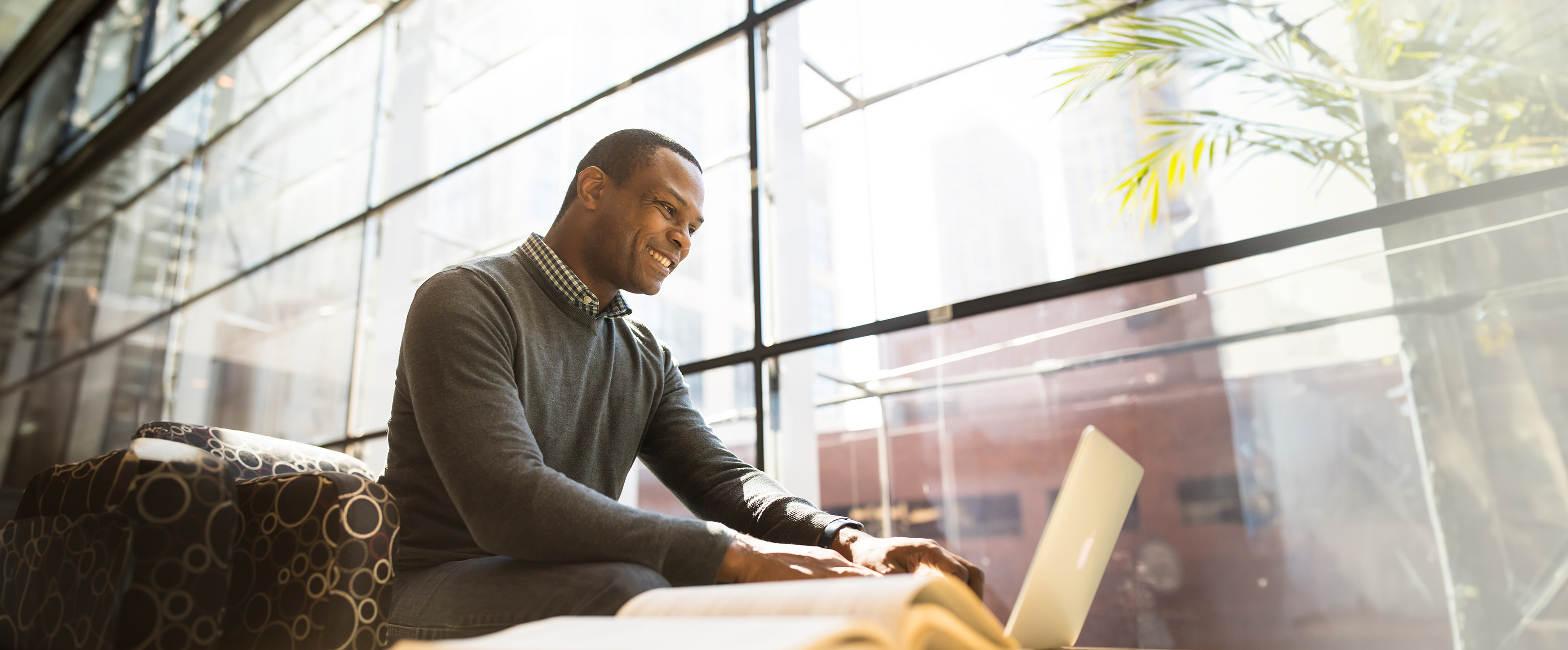 student working on his computer in the Loyola Water Tower business building