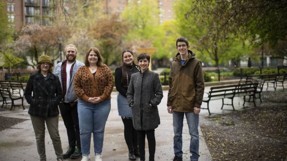 The six Loyola graduates that started Bug House Production company stand together in Washington Square Park in Chicago, IL.