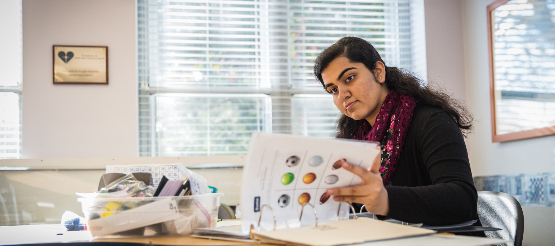 Armeen Sayani reviews teaching materials at her desk.