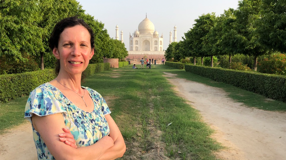 Tracy Pintchman stands for a photo in front of the Taj Mahal in India.