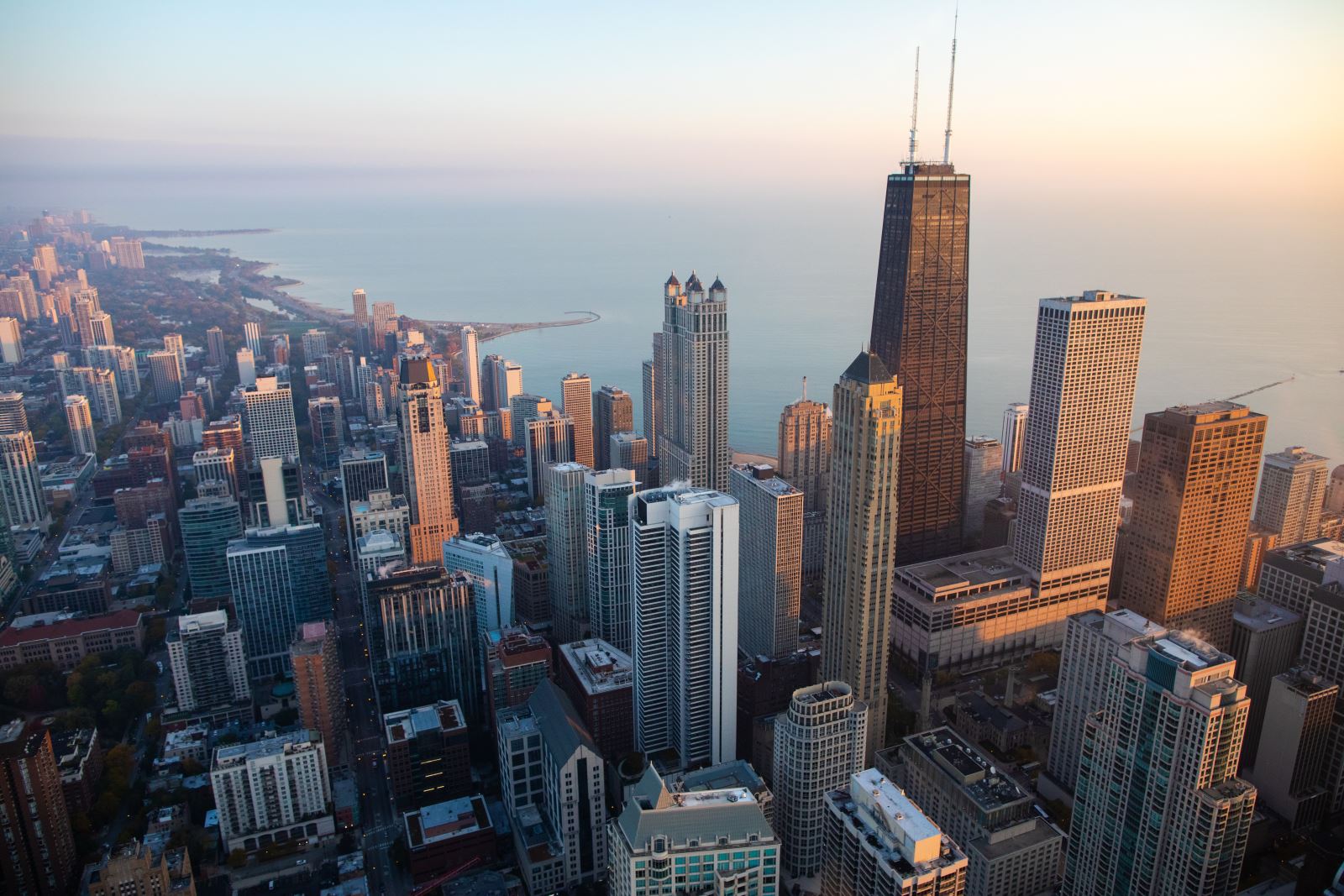Aerial view of city skyline featuring tall buildings and a waterway