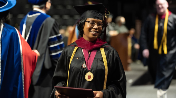 Photo of Asia Singleton receiving her degree