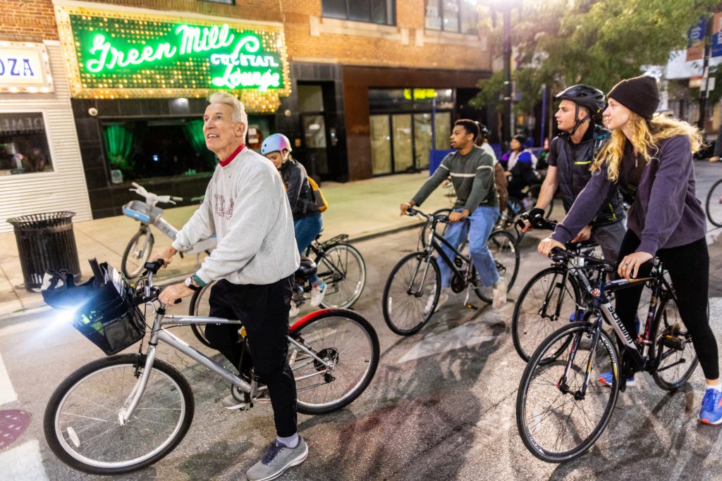 Photo of Dr. Gilfoyle and students on a nighttime bike ride through Chicago